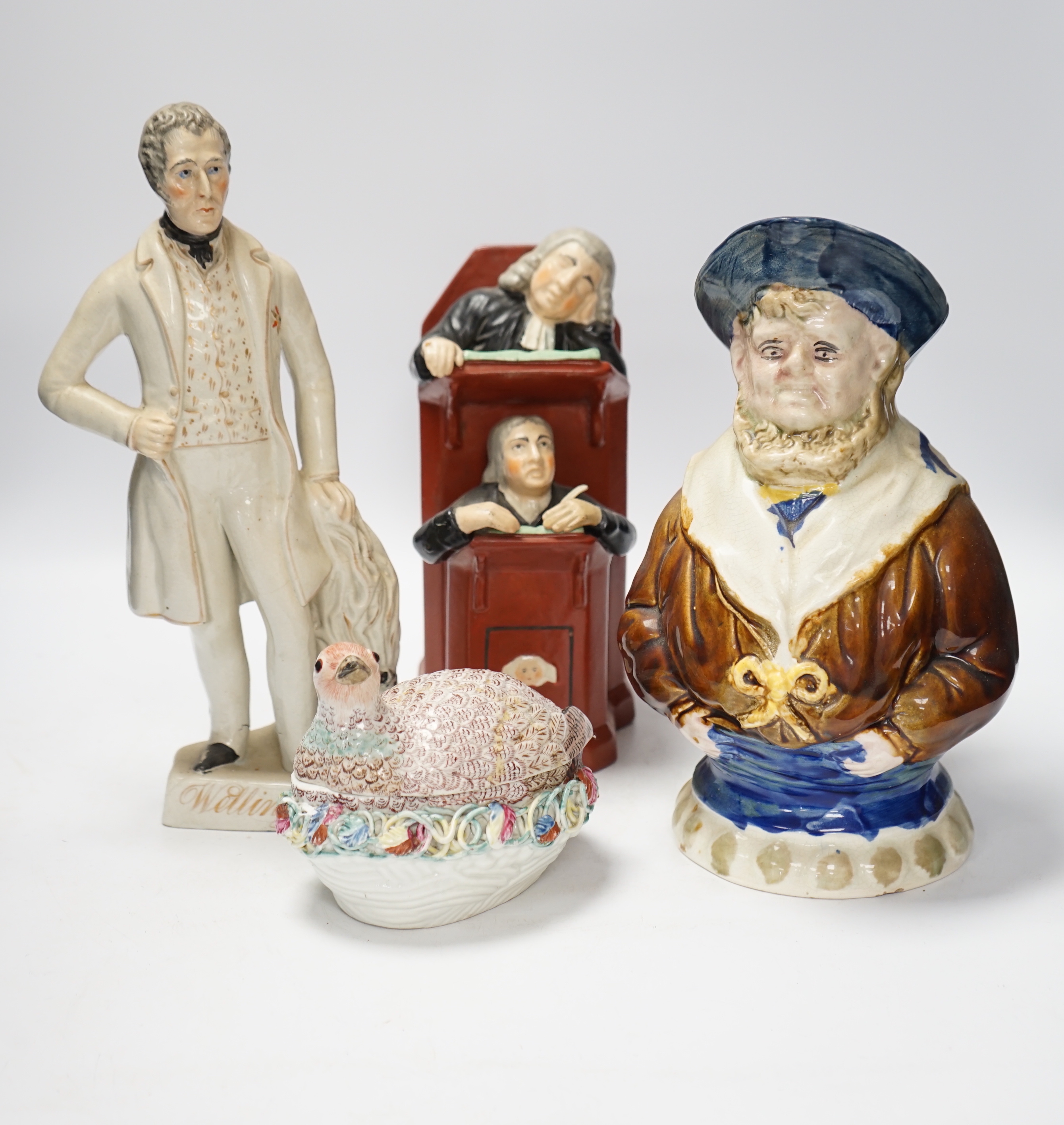 A Staffordshire figure of Wellington, a majolica sailor jug and a Vicar and Moses group, largest 32cm high